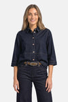 Dark blue denim long-sleeve shirt by STREET ONE, featuring front buttons and rolled cuffs, worn with matching jeans and leopard-print belt in lifestyle front view.