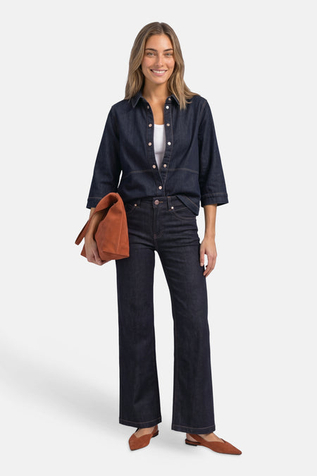 Dark blue denim long-sleeve shirt by STREET ONE, button-down front, rolled sleeves, worn with matching jeans and brown suede bag and shoes, full-length lifestyle view