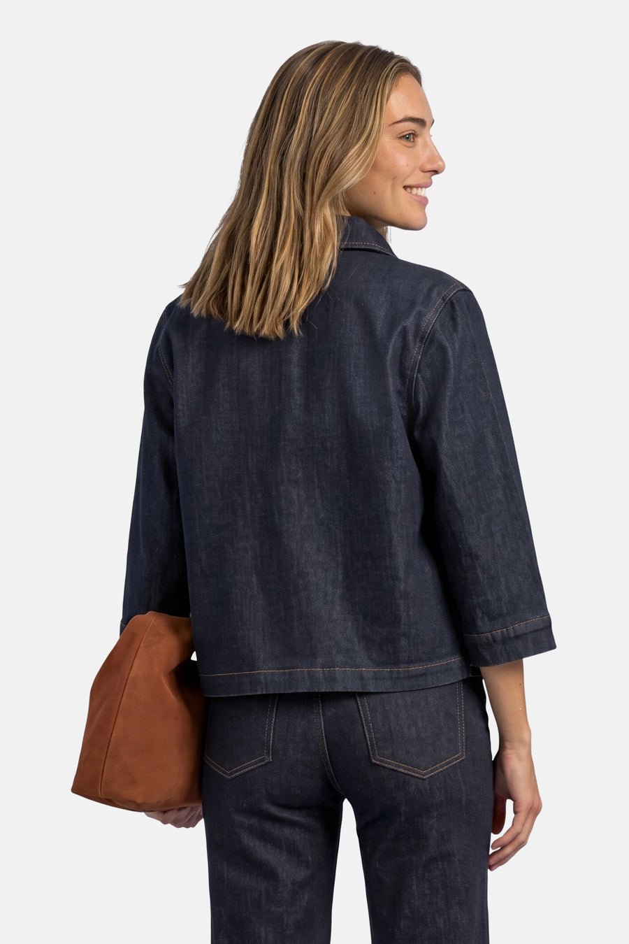 Dark blue denim long-sleeve shirt by STREET ONE, back view with rolled cuffs and brown tote bag.