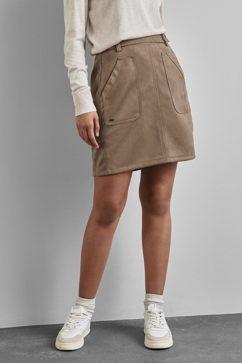 Jupe courte beige de STREET ONE, avec poches plaquées et finitions façon daim, portée avec un pull crème.
