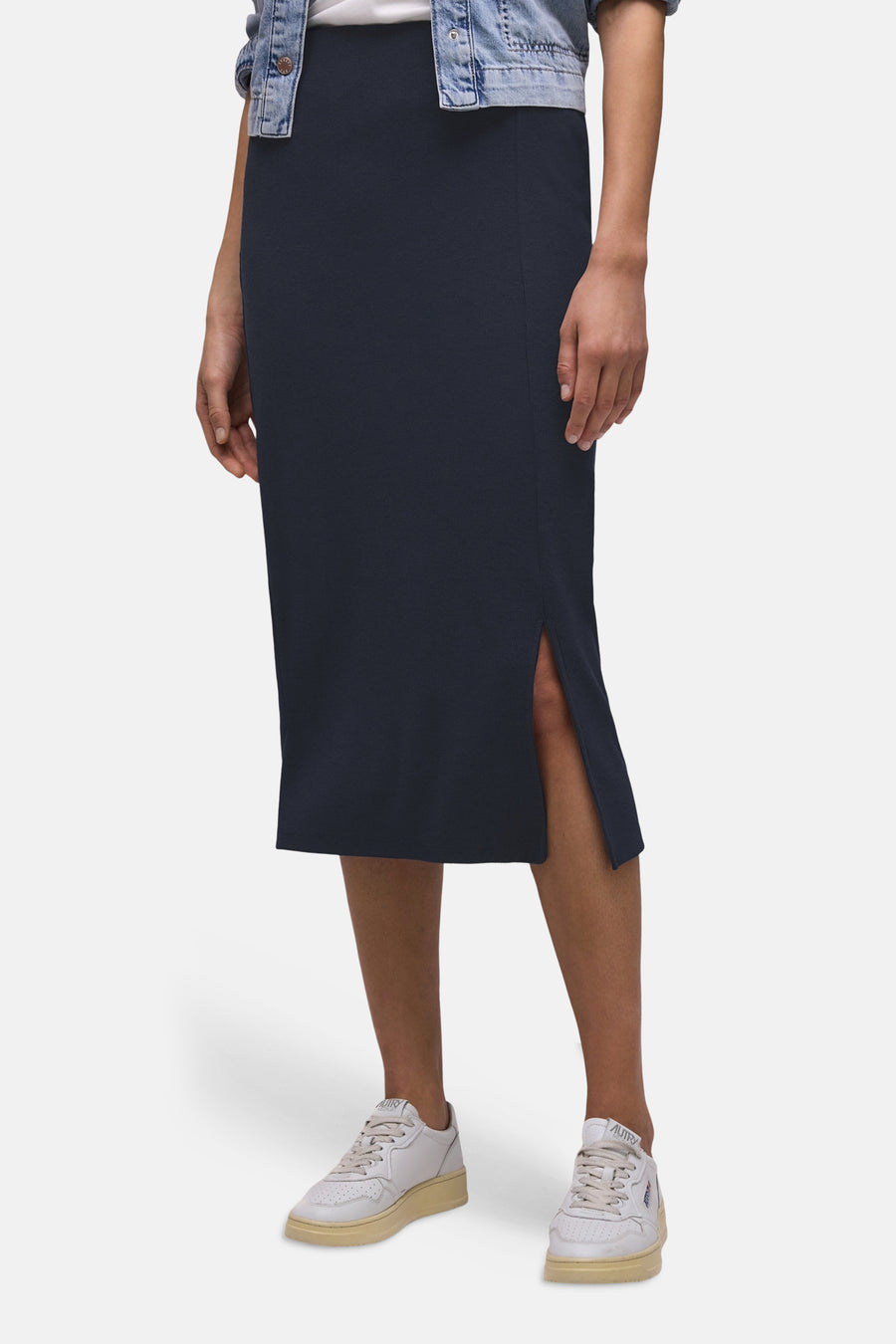 Jupe mi-longue bleue de STREET ONE, coupe droite avec fente latérale, portée avec une veste en jean et des baskets blanches.