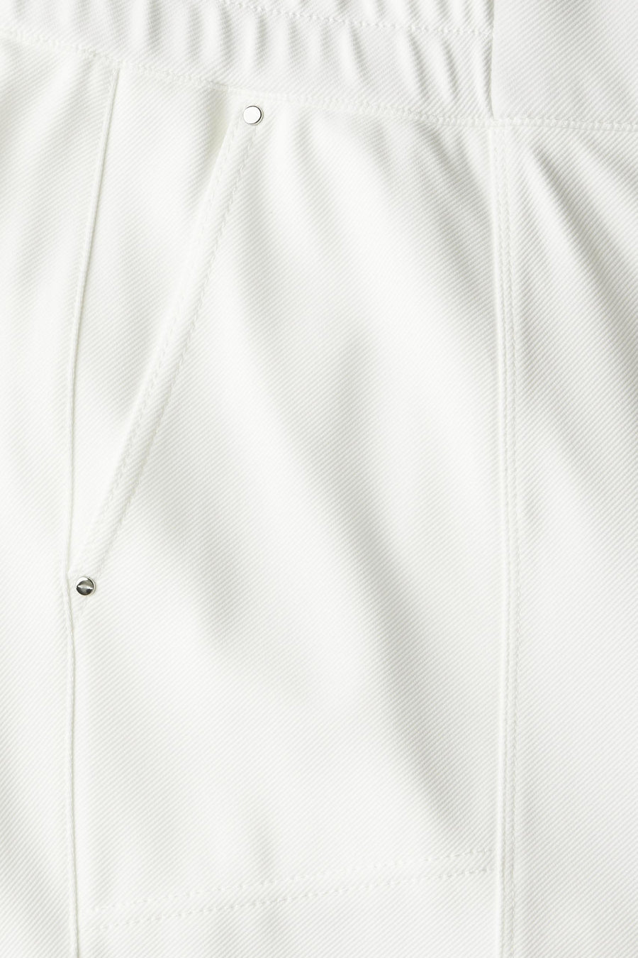 Pantalon blanc de STREET ONE, détail de poche avec fermeture à bouton et coutures apparentes.
