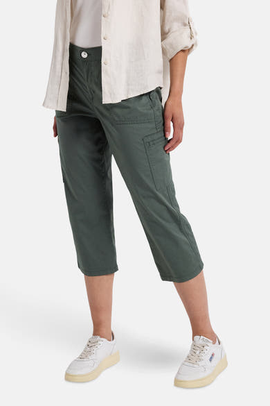 Pantalon cargo vert de STREET ONE, avec poches latérales et porté avec une chemise blanche.