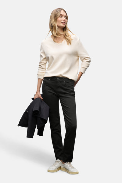 Zwarte denim slim fit jeans van STREET ONE, gedragen met een witte trui en witte sneakers.