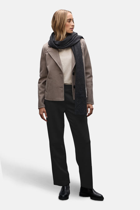 Pantalon de costume noir par STREET ONE, porté avec une veste beige, un pull et une écharpe grise.