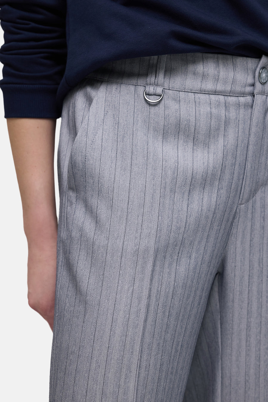 Blauwe kostuumbroek van STREET ONE met fijne verticale strepen en metalen details bij de taille, in close-up.