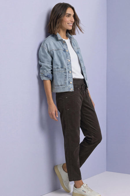 Brown corduroy pants by STREET ONE with drawstring waist, side pockets, and relaxed fit, shown in lifestyle pose with denim jacket and white sneakers.