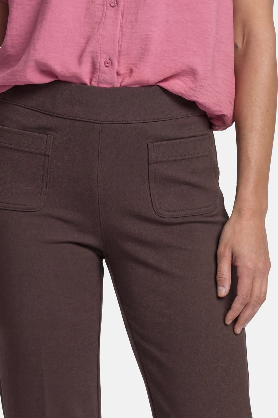 Brown tailored trousers with elastic waistband and back pockets by STREET ONE, shown on model in side view with pink top.