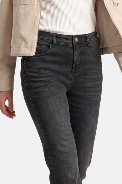 Black bootcut denim jeans by STREET ONE, featuring subtle fading, front pockets, and a rose gold button, shown on model with ribbed top and beige jacket.