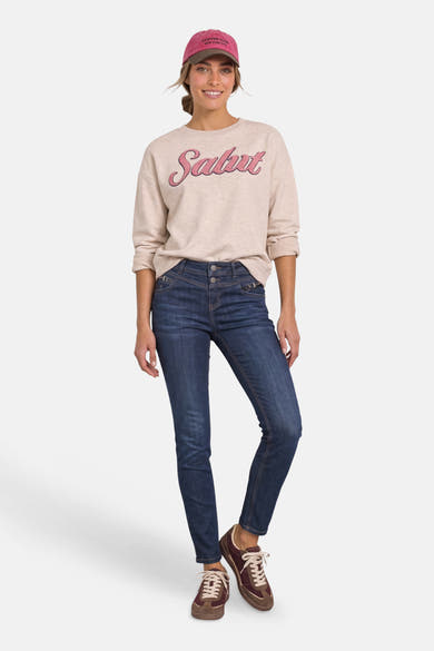 Dark blue slim-fit denim jeans by STREET ONE, featuring subtle fading and a clean front view with model wearing beige sweatshirt and maroon sneakers.