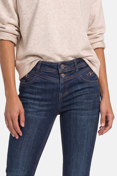 Dark blue slim-fit denim jeans by STREET ONE, featuring contrast stitching and front pockets, worn with a beige top in a cropped front view.