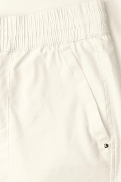 White elastic-waist women's seasonal pants by STREET ONE, featuring clean stitching and a side pocket with button detail, close-up view