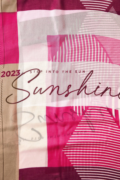 Rose-colored foulard with bold pink and white stripes, graphic text "Sunshine" and "2023 Step Into The Sun", sheer lightweight fabric, close-up view
