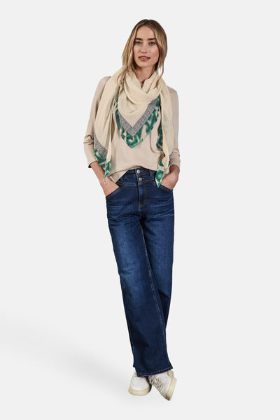 Foulard multicolore de Street One, porté autour du cou avec un pull beige et un jean bleu foncé.