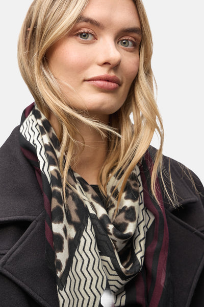 Foulard multicolore de Street One avec motif léopard et géométrique, porté avec un manteau noir.
