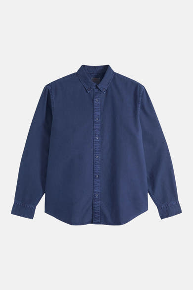 Blue long-sleeve shirt with button-down front and classic collar, featuring subtle stitching details and a relaxed fit, shown in front view.