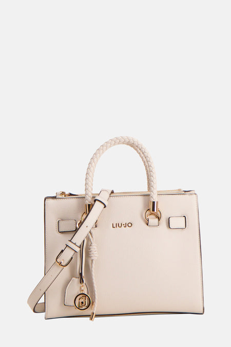 Sac à main écru de LIU JO avec bandoulière réglable et détails dorés, orné d'un pendentif décoratif.