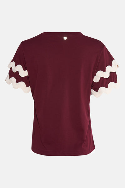 T-shirt bordeaux à manches courtes de AMELIE ET AMELIE, avec détail cœur et bordure ondulée blanche aux manches.