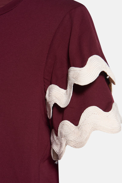 T-shirt bordeaux à manches courtes par AMELIE ET AMELIE, avec détail ondulé ivoire aux manches.