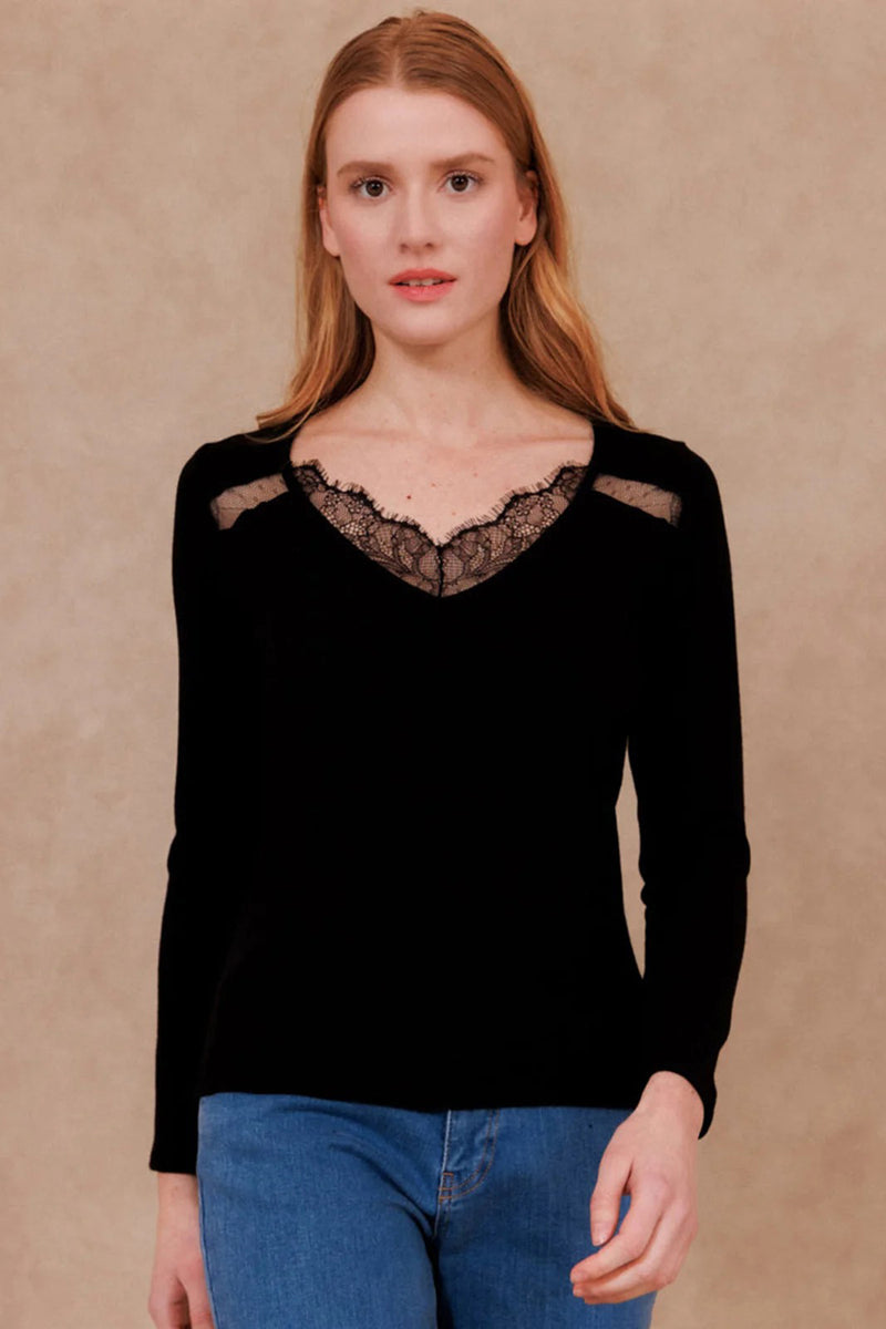 Black long-sleeve T-shirt with lace V-neck detail, worn with blue jeans, front view