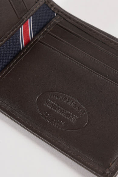 Portefeuille en cuir marron par Tommy Jeans avec rayures bleu marine, blanches et rouges.