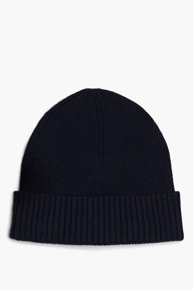 Marineblauwe muts van Tommy Jeans, in ribgebreide stof, met een klassieke omslag.