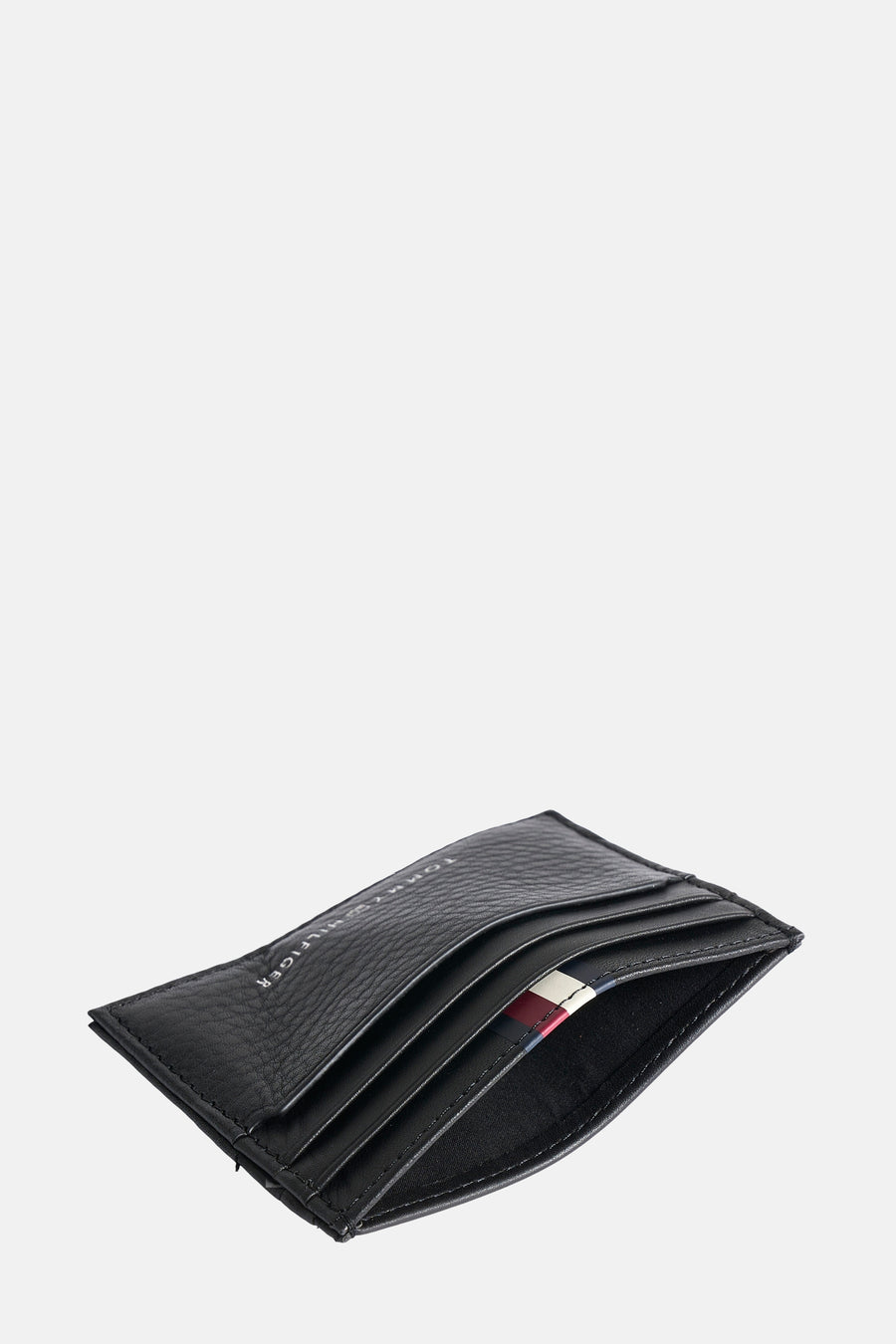 Porte-monnaie noir en cuir par TOMMY JEANS, avec rayures rouge, blanc et bleu.