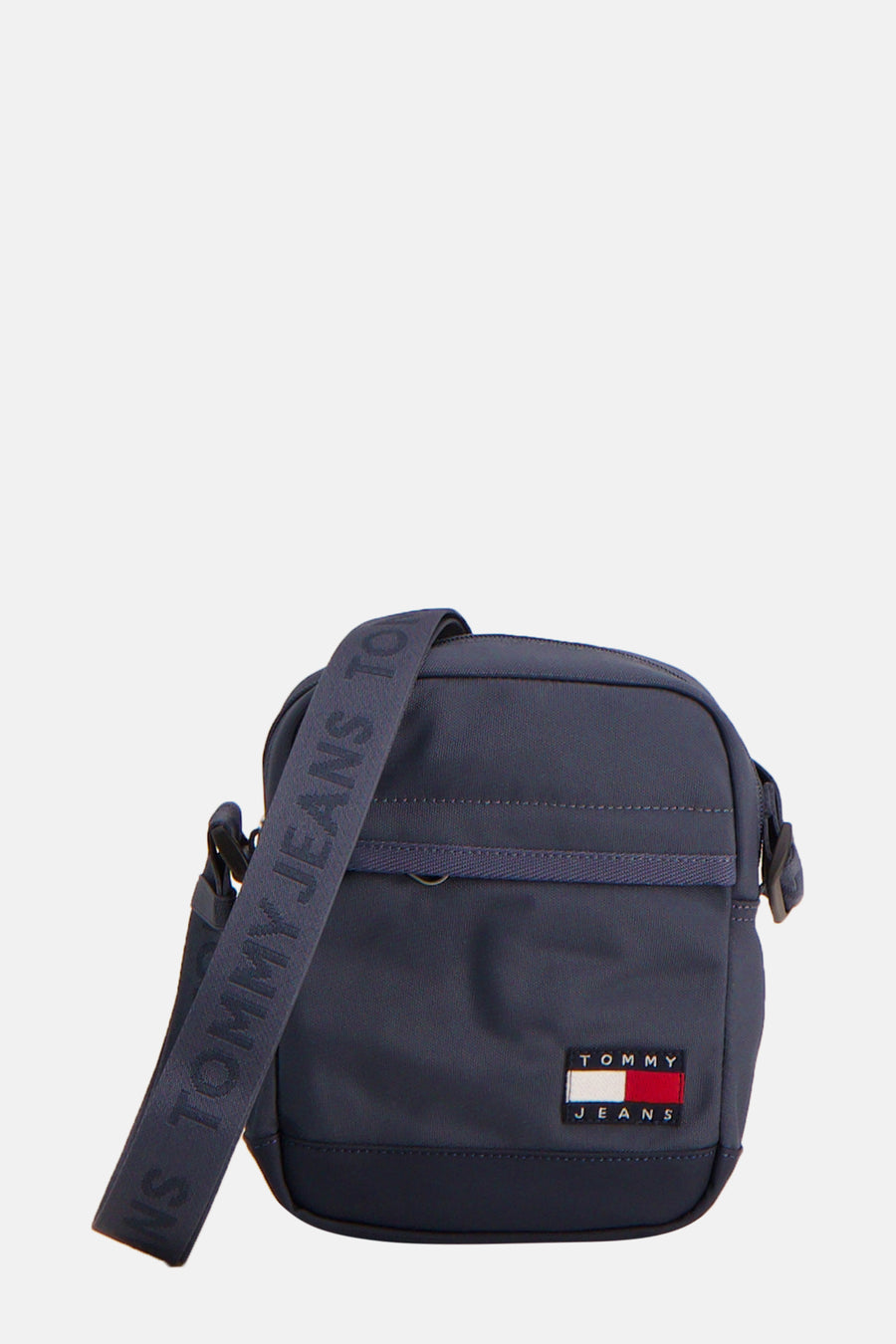 Sac à bandoulière bleu marine de TOMMY JEANS, avec une bandoulière portant le nom de la marque.