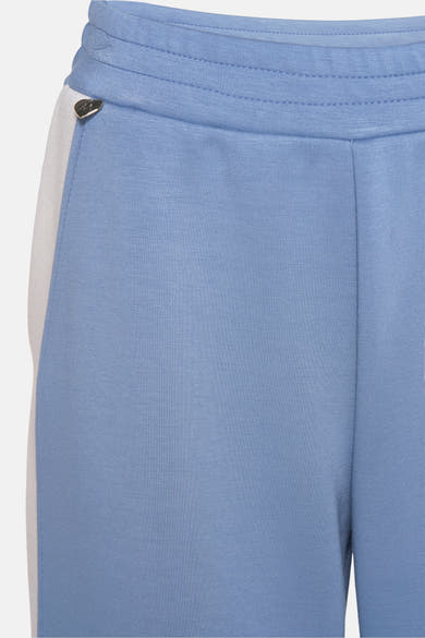 Jogging bleu clair de AMELIE ET AMELIE, avec bande blanche sur le côté et taille élastique.