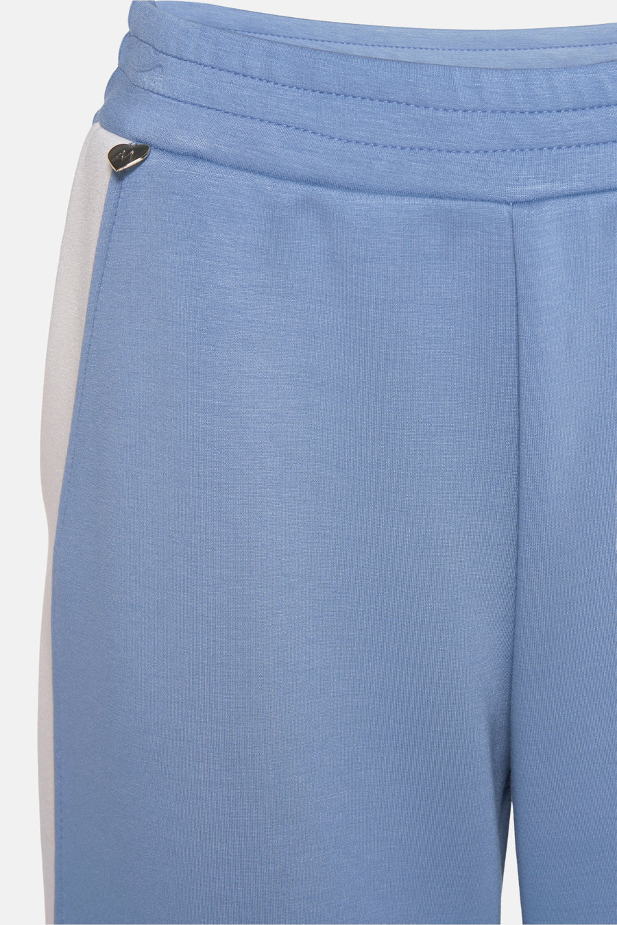 Jogging bleu clair de AMELIE ET AMELIE, avec bande blanche sur le côté et taille élastique.
