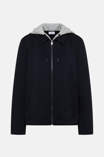 Veste courte bleue par CECIL avec capuche grise et fermeture éclair argentée.