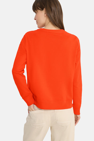 Oranje sweatshirt met ronde hals van CECIL, met lange mouwen en geribbelde zoom, gedragen met een beige broek.