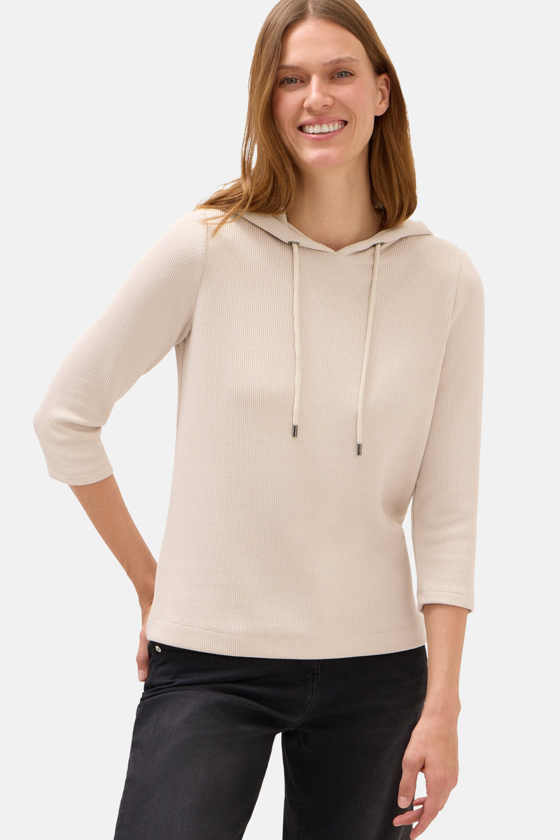 Beige hoodie van Cecil, met trekkoord en driekwartmouwen, gedragen met een zwarte jeans.