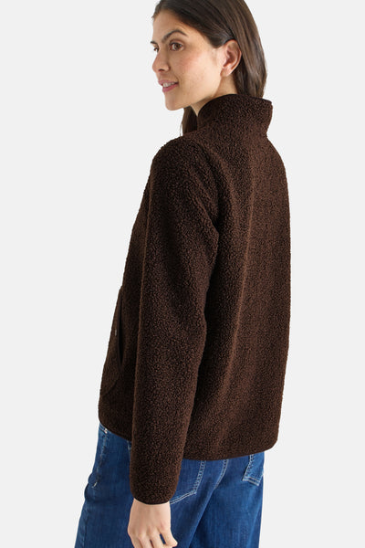 Kort bruin jasje van bouclé stof van CECIL, met een opstaande kraag en gedragen over een blauwe jeans.