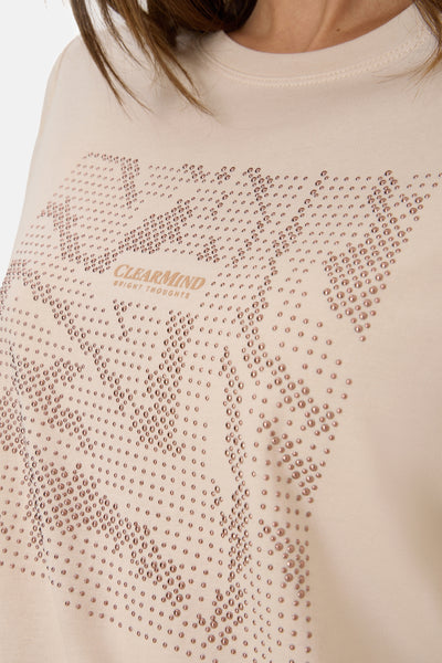 Beige T-shirt met lange mouwen van CECIL, versierd met strass in een grafisch patroon en de tekst "CLEARMIND".