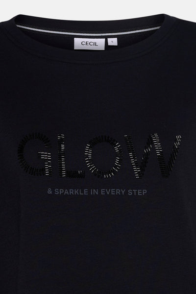 Top uni manches courtes noir de CECIL, avec l'inscription pailletée "GLOW & SPARKLE IN EVERY STEP".