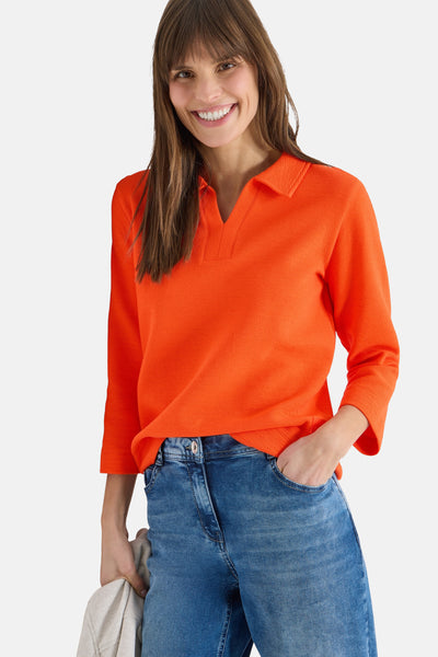 Oranje poloshirt met lange mouwen van CECIL, gedragen met een blauwe jeans en een casual stijl.
