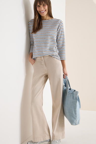 T-shirt à manches longues multicolore de CECIL, rayures horizontales, porté avec un pantalon beige et un sac en jean.