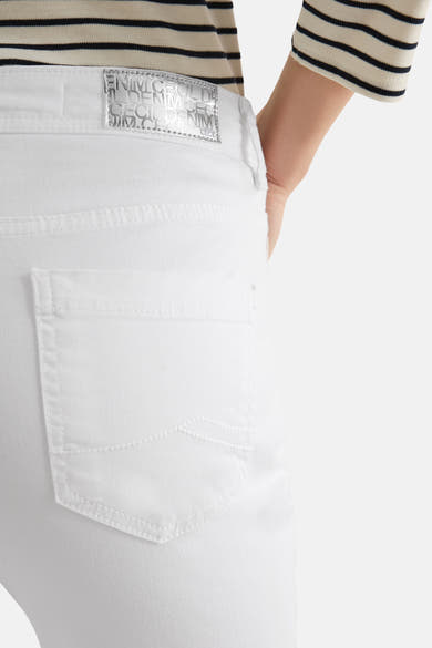 Jean droit en denim blanc de CECIL, détail de la poche arrière, porté avec un haut à rayures.
