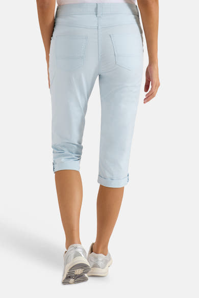 Pantalon cargo bleu clair de CECIL, vue arrière avec ourlets retroussés et baskets argentées.