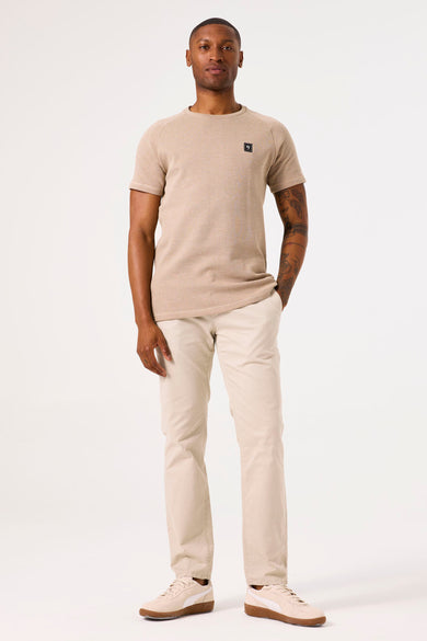 Beige T-shirt met korte mouwen van GARCIA, met een klein vierkant logo en een crèmekleurige broek.
