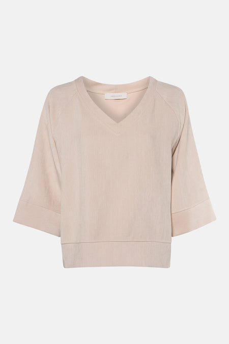 Ecru long-sleeve blouse with V-neck and ribbed texture by Amélie & Amélie, front view, cropped hem and cuffs