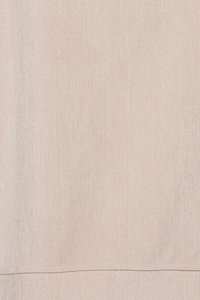 Ecru long-sleeve blouse with fine herringbone texture, close-up view of fabric detail