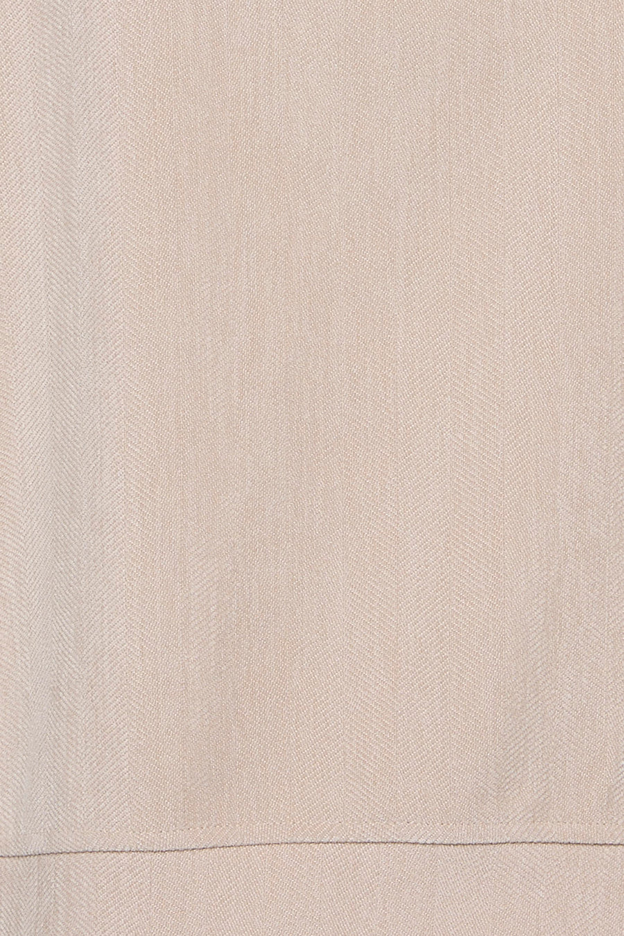 Ecru long-sleeve blouse with fine herringbone texture, close-up view of fabric detail