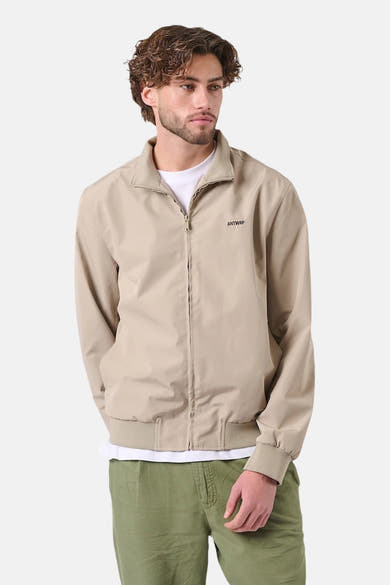 Veste de pluie beige de ANTWRP, coupe droite avec fermeture éclair et logo discret.
