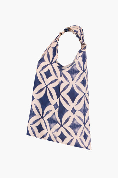 Blue and cream geometric patterned sleeveless blouse with halter neck and ruched straps, front view