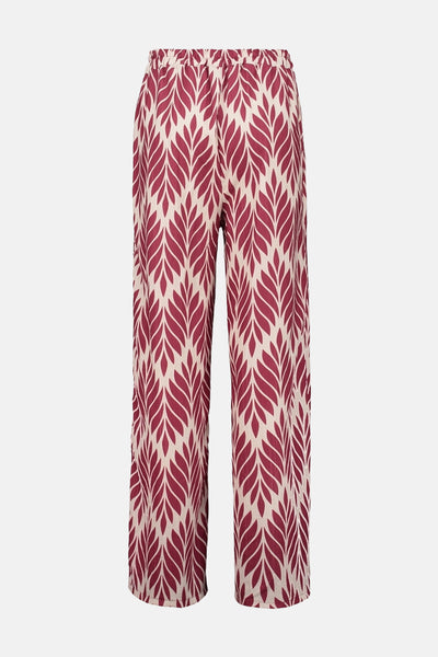 Pantalon multicolore de Zabaione, avec un motif de feuilles bordeaux et beige.