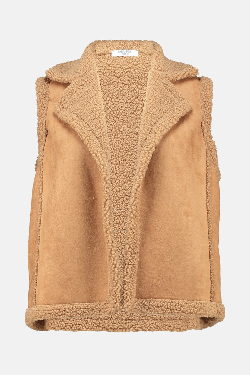 Veste cognac en peau lainée de Zabaione, avec col tailleur et ourlet en fausse fourrure.