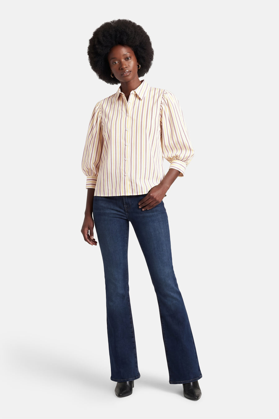 Multikleurig overhemd met korte mouwen van AMELIE ET AMELIE, met gele en paarse verticale strepen, gedragen met een donkerblauwe jeans.