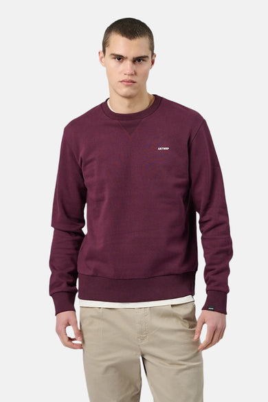 Bordeaux crewneck sweatshirt by Antwerp with small chest logo, ribbed cuffs and hem, front view on model wearing beige pants
